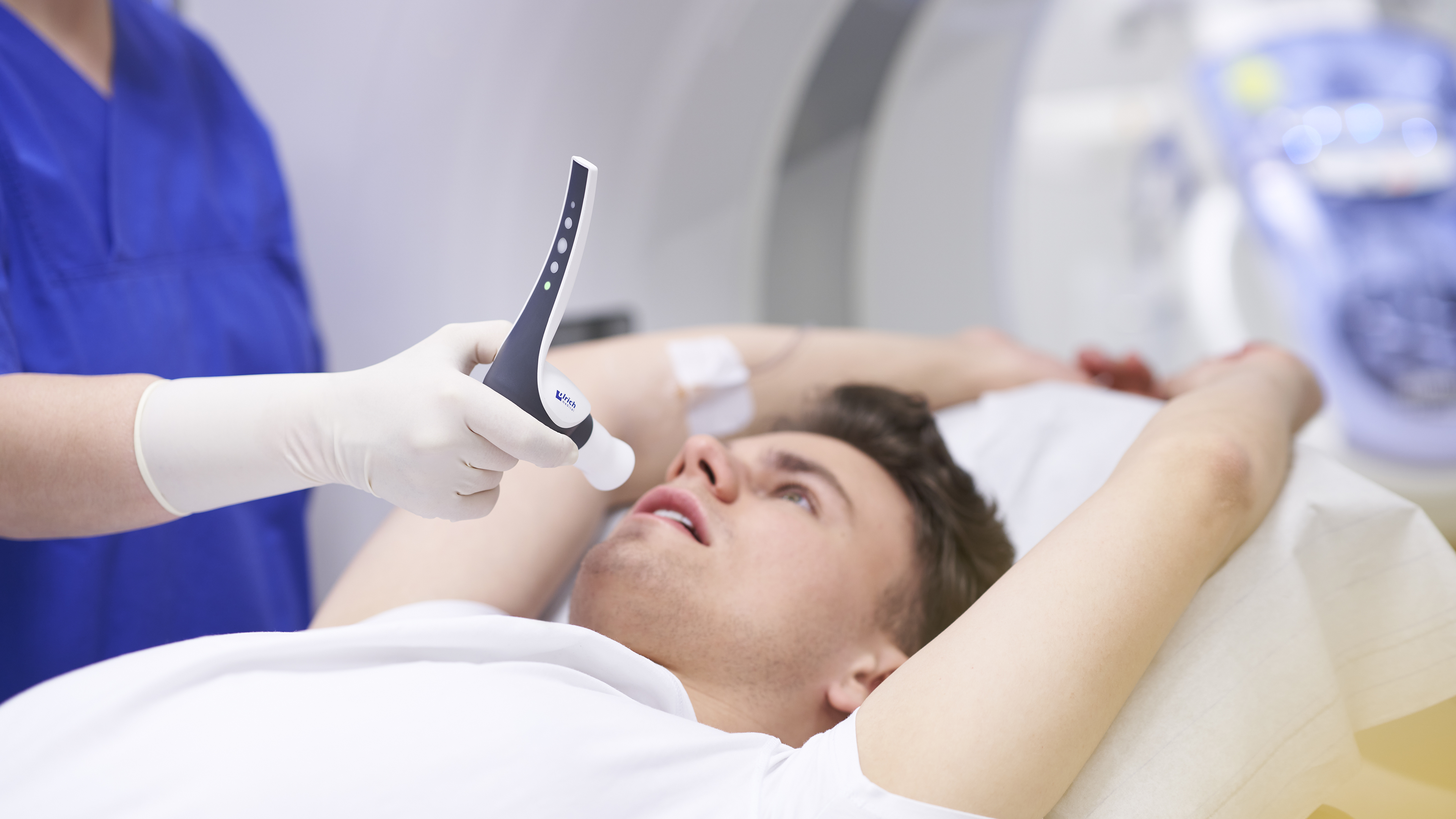 A radiographer hands a patient the Contrast Booster from ulrich medical for a pulmonary embolism CT scan.